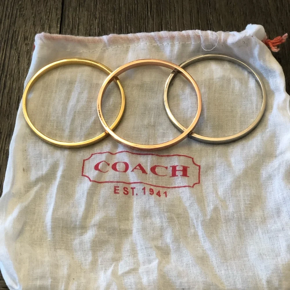 Coach bracelet set including a gold, silver and rose gold bangle. - Picture 2 of 3